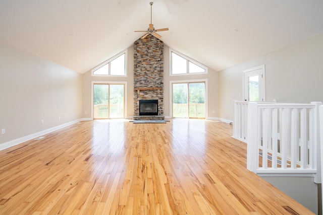 7885 Upper Twin Rd, South Salem, OH 45681 - unfurnished living room featuring a ceiling fan, light wood-type flooring, a fireplace, high vaulted ceiling, and baseboards