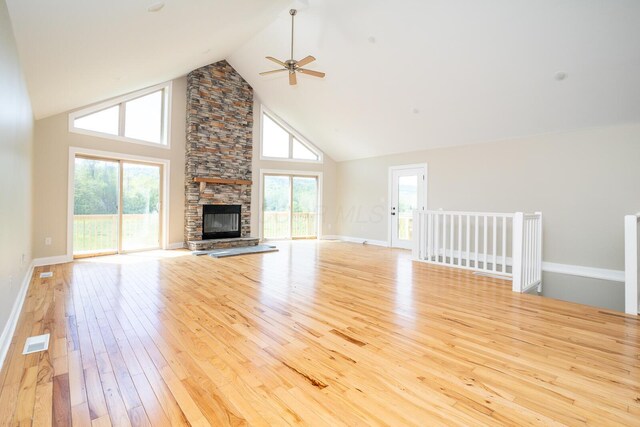 7885 Upper Twin Rd, South Salem, OH 45681 - unfurnished living room featuring a ceiling fan, high vaulted ceiling, hardwood / wood-style floors, a stone fireplace, and baseboards