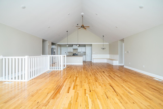 7885 Upper Twin Rd, South Salem, OH 45681 - unfurnished living room with ceiling fan, light wood-style flooring, lofted ceiling, and baseboards