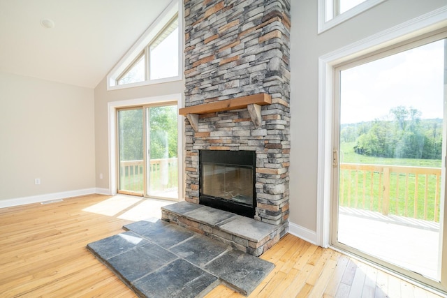 7885 Upper Twin Rd, South Salem, OH 45681 - unfurnished living room with baseboards, hardwood / wood-style flooring, a fireplace, and high vaulted ceiling
