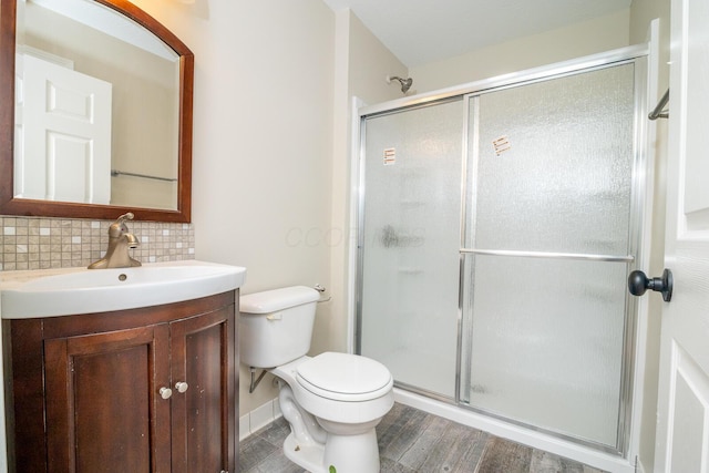 7885 Upper Twin Rd, South Salem, OH 45681 - bathroom with backsplash, a shower stall, vanity, toilet, and wood finished floors