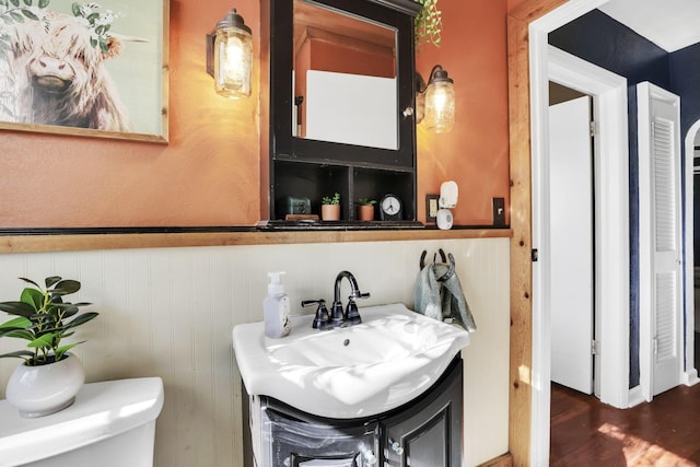 7677 Opossum Run Rd, London, OH 43140 - half bathroom featuring toilet, wood finished floors, and vanity