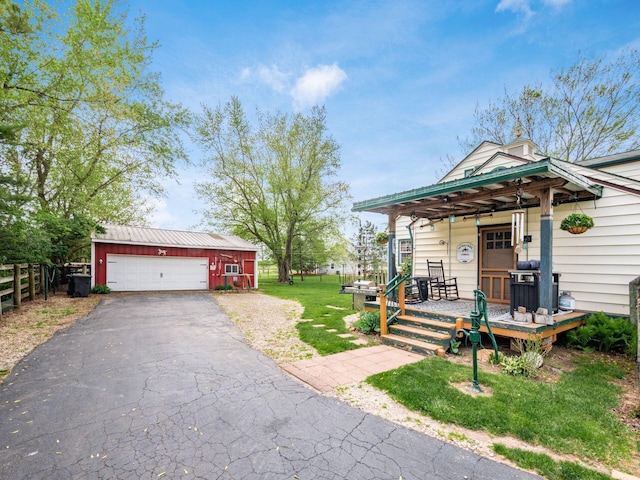 7677 Opossum Run Rd, London, OH 43140 - view of front of home with an outdoor structure and asphalt driveway