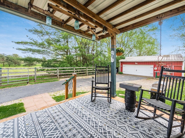 7677 Opossum Run Rd, London, OH 43140 - view of patio featuring an outdoor structure, a detached garage, and fence