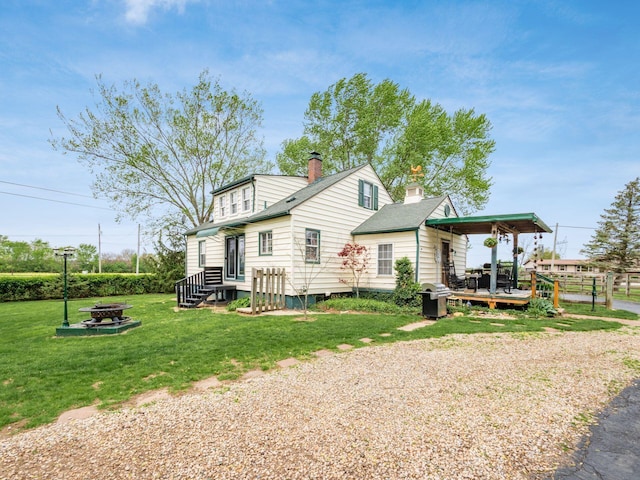 7677 Opossum Run Rd, London, OH 43140 - view of home's exterior with an outdoor fire pit, a chimney, and a deck