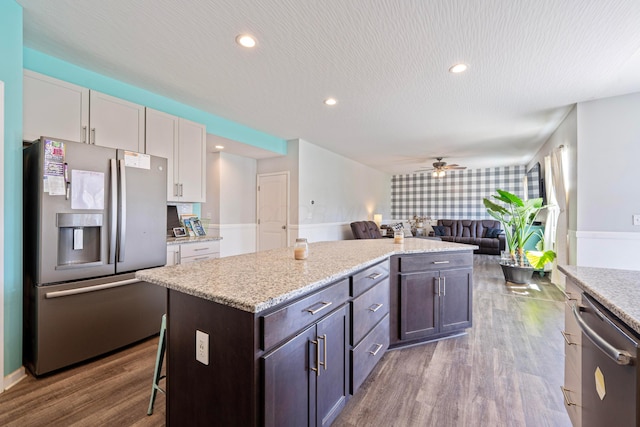 331 Hardwood Ave, Circleville, OH 43113 - kitchen featuring appliances with stainless steel finishes, a kitchen island, open floor plan, dark wood-type flooring, and a ceiling fan