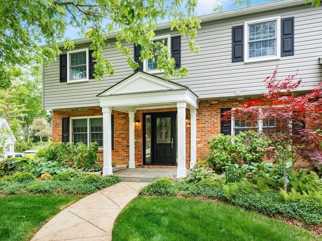 view of front of property featuring brick siding