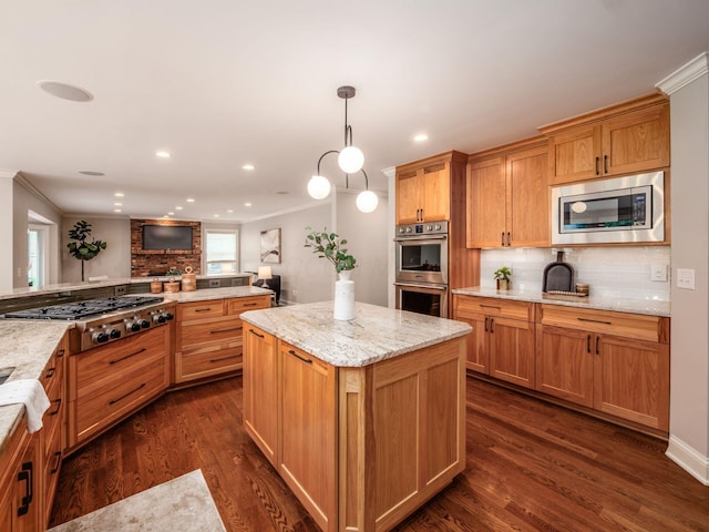 kitchen with appliances with stainless steel finishes, backsplash, ornamental molding, dark wood-style flooring, and a center island