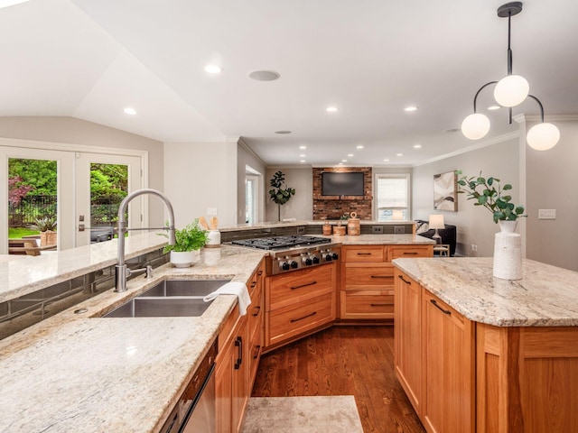 kitchen featuring a sink, stainless steel gas cooktop, dark wood-style floors, light stone countertops, and crown molding