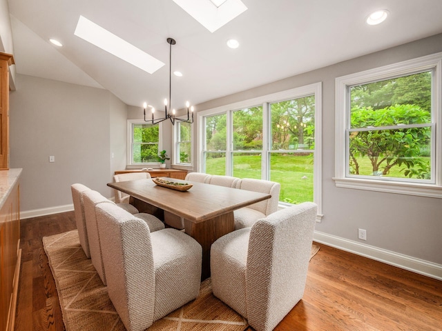 dining space featuring a skylight, healthy amount of natural light, baseboards, and recessed lighting