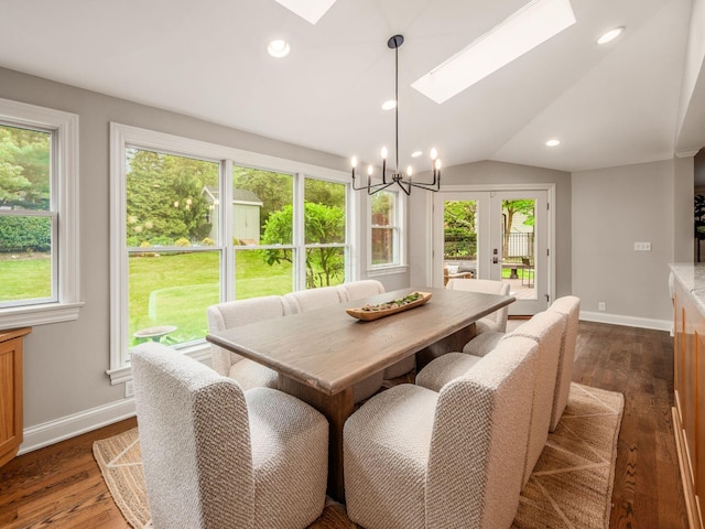 dining room featuring a skylight, a chandelier, baseboards, dark wood-type flooring, and recessed lighting