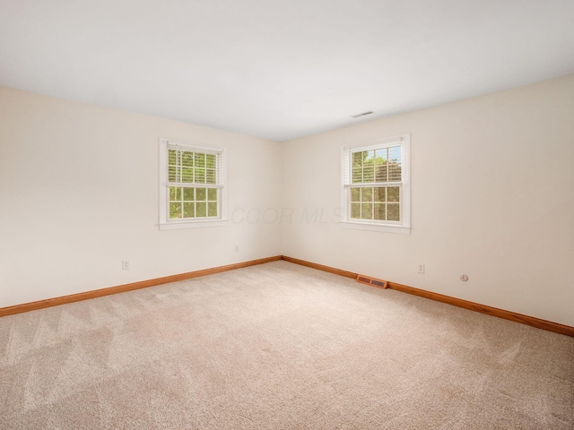 unfurnished room with baseboards and carpet floors