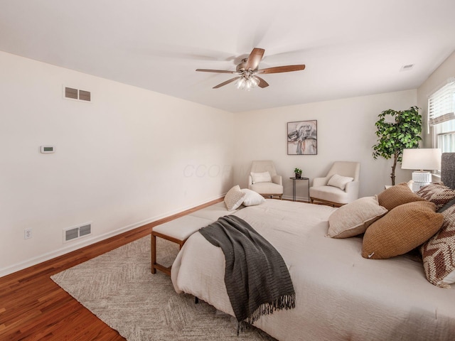 bedroom with wood finished floors, baseboards, and ceiling fan