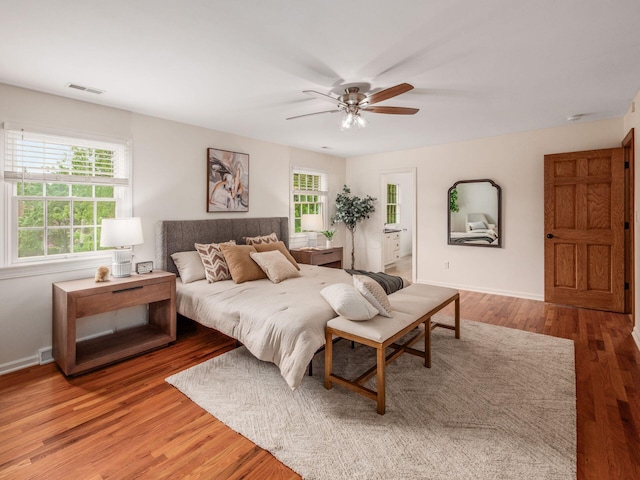 bedroom with wood finished floors, baseboards, and ceiling fan