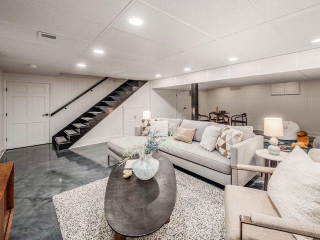 living area with stairway, recessed lighting, and a paneled ceiling