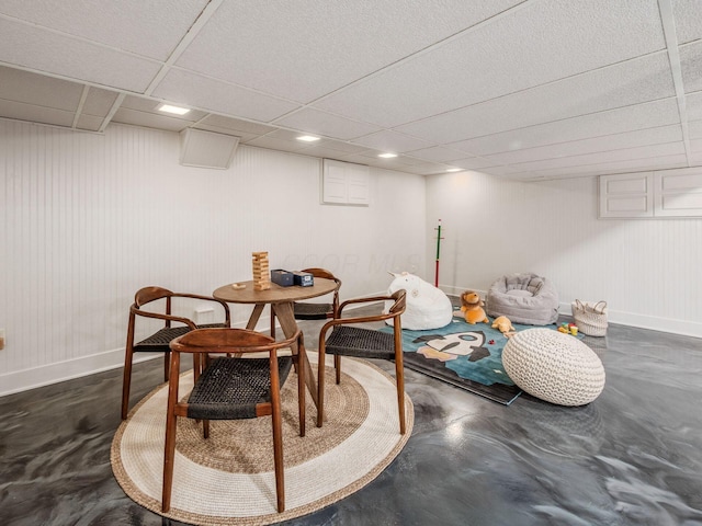 dining area featuring baseboards, a paneled ceiling, concrete floors, and recessed lighting