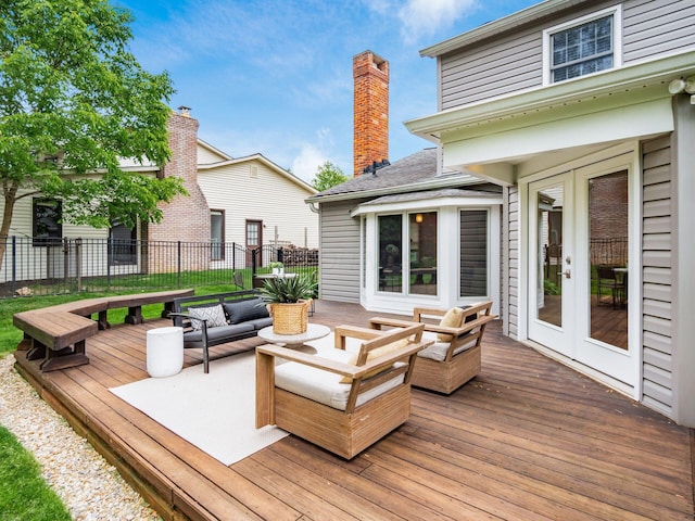 deck with french doors, fence, and outdoor lounge area