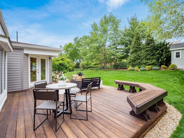 wooden deck featuring french doors, a yard, and outdoor dining area