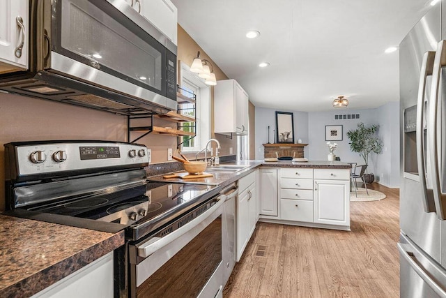 8950 Woodhaven Rd, Johnstown, OH 43031 - kitchen featuring appliances with stainless steel finishes, a sink, a peninsula, white cabinets, and recessed lighting