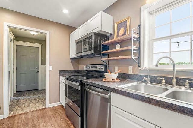 8950 Woodhaven Rd, Johnstown, OH 43031 - kitchen with appliances with stainless steel finishes, a sink, dark countertops, white cabinetry, and recessed lighting