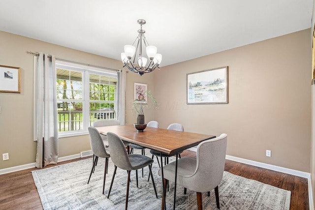 8950 Woodhaven Rd, Johnstown, OH 43031 - dining space featuring a chandelier, baseboards, and wood finished floors