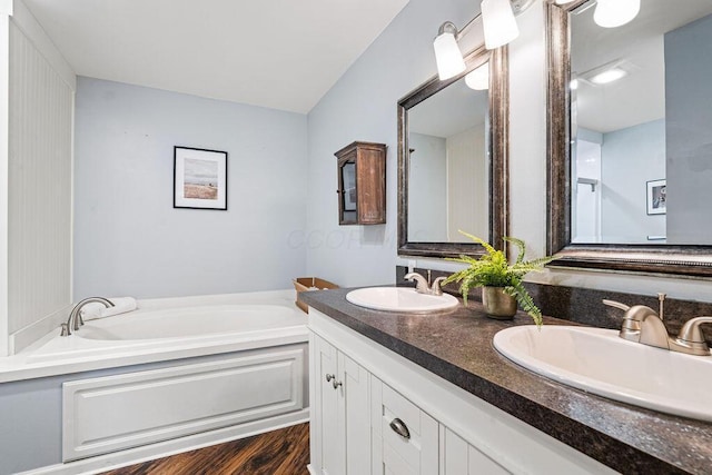 8950 Woodhaven Rd, Johnstown, OH 43031 - full bathroom with a garden tub, double vanity, and wood finished floors