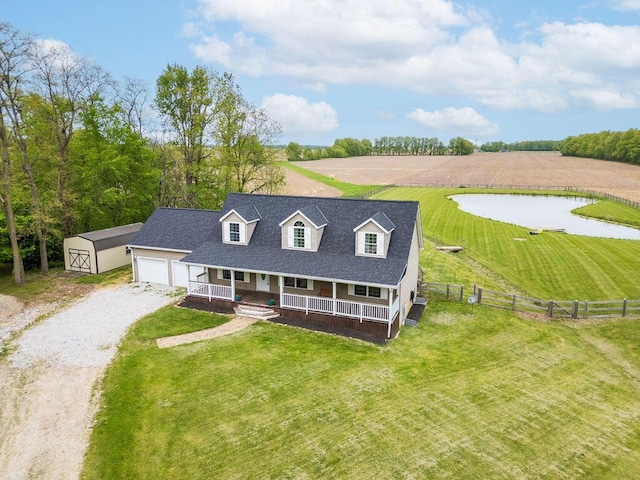 8950 Woodhaven Rd, Johnstown, OH 43031 - view of front of home with a porch, driveway, a storage shed, an outbuilding, and a water view
