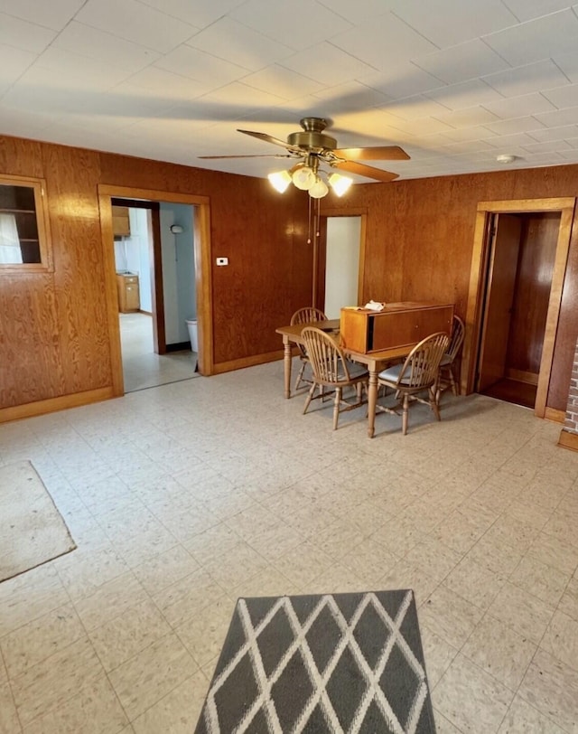 7378 Irvin Shoots Rd W, Morral, OH 43337 - dining room featuring light floors, wood walls, and ceiling fan