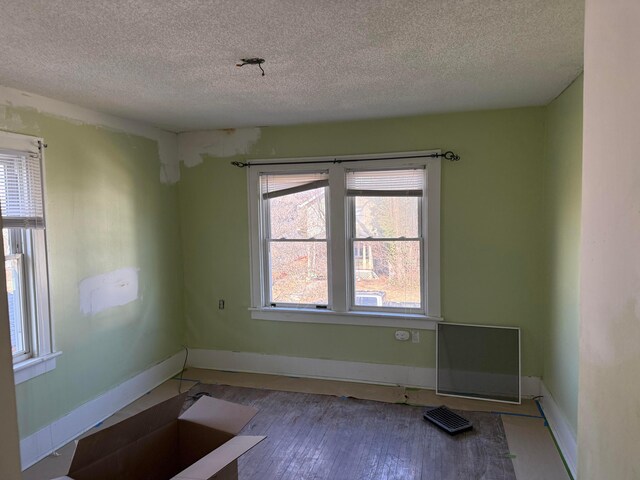1413 Minnesota Ave, Columbus, OH 43211 - spare room with a textured ceiling, baseboards, and wood finished floors