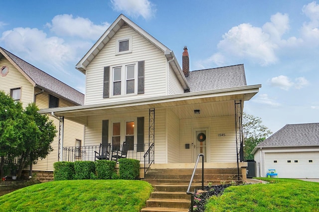 1545 Westwood Ave, Columbus, OH 43212 - view of front of home featuring a porch, a chimney, a front lawn, and a garage