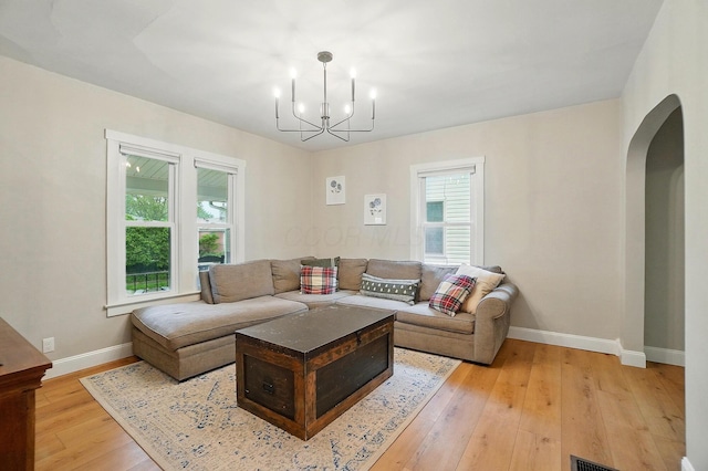 1545 Westwood Ave, Columbus, OH 43212 - living area featuring arched walkways, plenty of natural light, a chandelier, and light wood-style flooring
