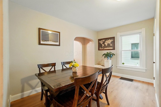 1545 Westwood Ave, Columbus, OH 43212 - dining room with baseboards, light wood-type flooring, and arched walkways