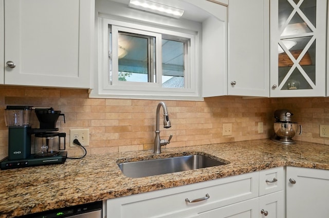 1545 Westwood Ave, Columbus, OH 43212 - kitchen featuring a sink, white cabinets, glass insert cabinets, and backsplash