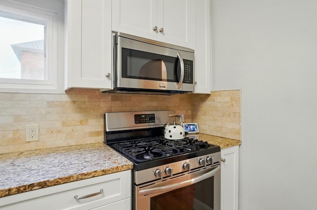 1545 Westwood Ave, Columbus, OH 43212 - kitchen with stainless steel appliances, white cabinetry, and backsplash
