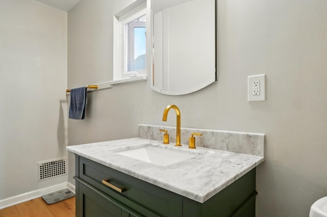 1545 Westwood Ave, Columbus, OH 43212 - half bathroom featuring vanity, baseboards, and wood finished floors