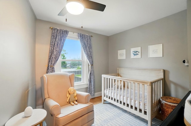 1545 Westwood Ave, Columbus, OH 43212 - bedroom with a nursery area, wood finished floors, ceiling fan, and baseboards