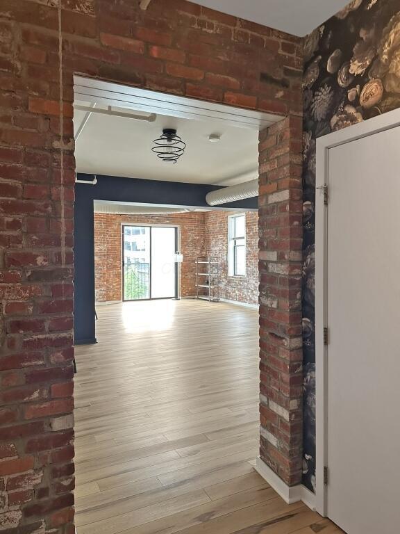 432 E Rich St Unit 3K, Columbus, OH 43215 - corridor with brick wall and wood finished floors