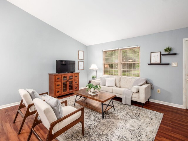 living room with baseboards, lofted ceiling, and wood finished floors