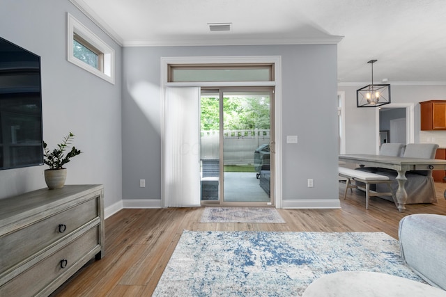 243 Parkgate Ct, Delaware, OH 43015 - living area with crown molding, baseboards, light wood-style floors, and plenty of natural light