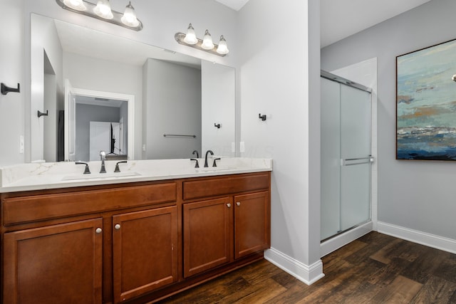 243 Parkgate Ct, Delaware, OH 43015 - bathroom with wood finished floors, baseboards, double vanity, and a stall shower