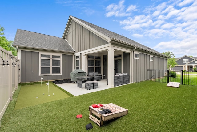 243 Parkgate Ct, Delaware, OH 43015 - rear view of property with board and batten siding, outdoor lounge area, a patio area, a putting green, and a shingled roof