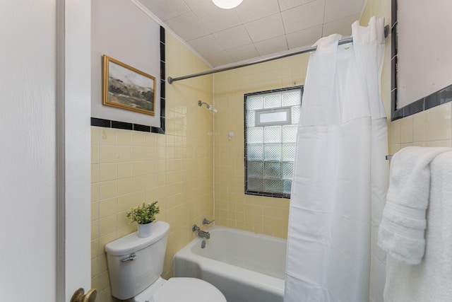 832 Oxley Rd, Columbus, OH 43212 - bathroom with tile walls, shower / tub combo with curtain, and toilet