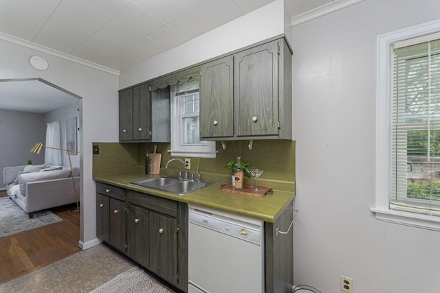 832 Oxley Rd, Columbus, OH 43212 - kitchen featuring a sink, white dishwasher, arched walkways, and light countertops