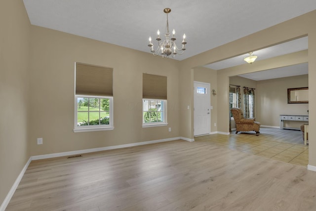 135 Tassel View St, Pataskala, OH 43062 - foyer with light wood-style flooring, a chandelier, and baseboards