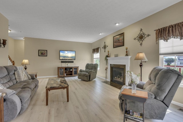 135 Tassel View St, Pataskala, OH 43062 - living room featuring a high end fireplace, plenty of natural light, light wood-style floors, baseboards, and recessed lighting