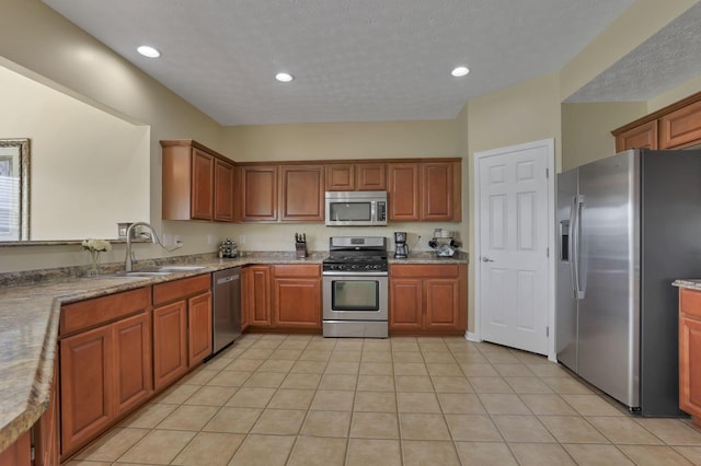 135 Tassel View St, Pataskala, OH 43062 - kitchen featuring stainless steel appliances, a sink, brown cabinets, recessed lighting, and light tile patterned floors