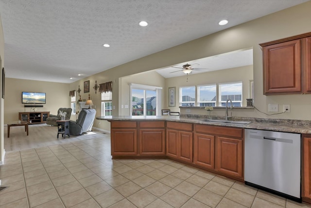 135 Tassel View St, Pataskala, OH 43062 - kitchen featuring dishwasher, a sink, open floor plan, a ceiling fan, and a peninsula