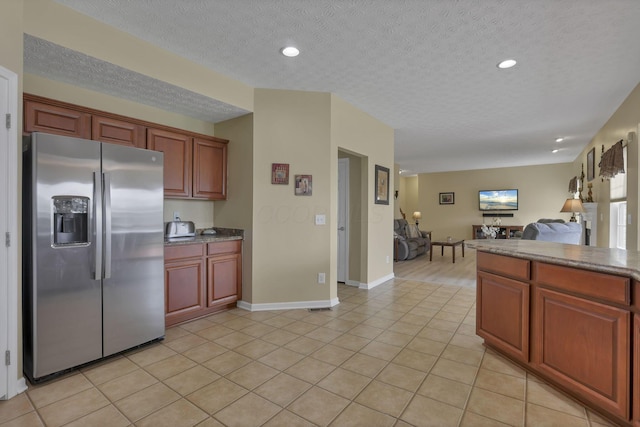 135 Tassel View St, Pataskala, OH 43062 - kitchen featuring stainless steel fridge with ice dispenser, open floor plan, light tile patterned flooring, a textured ceiling, and recessed lighting