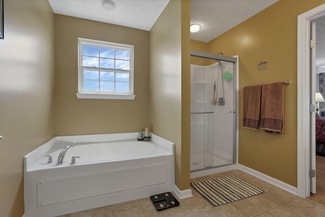 135 Tassel View St, Pataskala, OH 43062 - full bathroom with a shower stall, a bath, a textured ceiling, baseboards, and tile patterned floors
