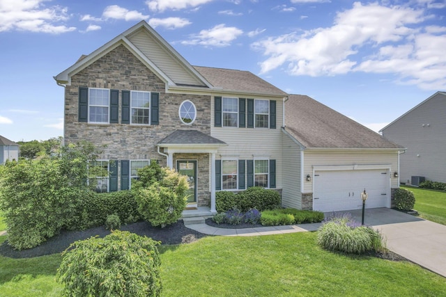 135 Tassel View St, Pataskala, OH 43062 - view of front facade featuring stone siding, a front yard, an attached garage, concrete driveway, and central AC